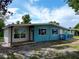 Charming single-story home with blue and white paint, inviting front porch, and well-maintained landscaping at 300 Dalton Blvd Blvd, Port Charlotte, FL 33952