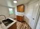 Well-lit laundry room features upper and lower cabinets with a stainless steel sink at 300 Dalton Blvd Blvd, Port Charlotte, FL 33952
