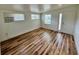 Living room featuring multiple windows, wood-look flooring, and a white front door at 300 Dalton Blvd Blvd, Port Charlotte, FL 33952