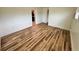 Room featuring white walls, wood-look flooring, and an open doorway at 300 Dalton Blvd Blvd, Port Charlotte, FL 33952
