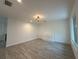 Well-lit bedroom boasts wood-look floors, recessed lighting, and a stylish chandelier at 4300 Avanti Cir, North Port, FL 34287