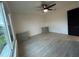 This bedroom features a ceiling fan, wood-look floors, and custom cabinets at 4300 Avanti Cir, North Port, FL 34287