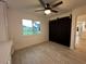 Spacious bedroom featuring custom barn doors and tiled flooring at 4300 Avanti Cir, North Port, FL 34287