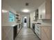 Modern kitchen with white cabinetry, sleek countertops, subway tile backsplash, and stainless steel appliances at 4300 Avanti Cir, North Port, FL 34287