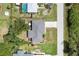 Overhead shot showcasing the house's roof, driveway, and surrounding neighborhood at 7104 Castilla St, Port Charlotte, FL 33981