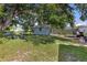 Large backyard featuring lush lawn, mature trees, and convenient shed for storage or hobbies at 7104 Castilla St, Port Charlotte, FL 33981