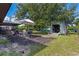 Outdoor entertaining space with patio set, large shade tree, and convenient storage shed at 7104 Castilla St, Port Charlotte, FL 33981