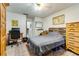 Bedroom featuring a queen bed, natural wood furniture, and a ceiling fan at 7104 Castilla St, Port Charlotte, FL 33981