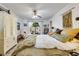 Bright bedroom includes a decorative dresser, floral bedding, white curtains, and access to the outdoors at 7104 Castilla St, Port Charlotte, FL 33981