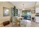 Inviting dining area with a glass table, ornate chairs, stylish decor, and sliding glass doors to the lanai at 7104 Castilla St, Port Charlotte, FL 33981