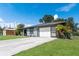 Lovely home exterior featuring a driveway, garage, and lush landscaping at 7104 Castilla St, Port Charlotte, FL 33981