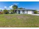 Charming single-story home featuring a well-maintained lawn and attached two-car garage at 7104 Castilla St, Port Charlotte, FL 33981