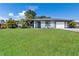 Charming single-story home featuring a well-maintained lawn and attached two-car garage at 7104 Castilla St, Port Charlotte, FL 33981