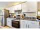 Close up of kitchen with stainless steel appliances, white cabinets, and dark countertops at 7104 Castilla St, Port Charlotte, FL 33981