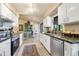 Bright kitchen with white cabinetry, stainless steel appliances, and an open view to the dining area at 7104 Castilla St, Port Charlotte, FL 33981