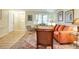 Bright living room features an orange sofa, area rug, and ample natural light at 7104 Castilla St, Port Charlotte, FL 33981