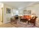 Bright living room features an orange sofa, area rug, and ample natural light at 7104 Castilla St, Port Charlotte, FL 33981