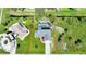 Aerial view showcases the home with a private pool, lush landscaping, and a well-maintained yard at 7453 Spinnaker Blvd, Englewood, FL 34224