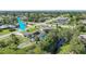 Aerial view of property showcasing the home, pool, landscaping, and neighborhood at 7453 Spinnaker Blvd, Englewood, FL 34224