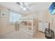 Comfortable bedroom featuring a bunk bed, ceiling fan and mounted TV at 7453 Spinnaker Blvd, Englewood, FL 34224
