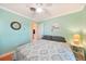 Comfortable bedroom featuring hardwood floors and a tropical beach themed wall art at 7453 Spinnaker Blvd, Englewood, FL 34224