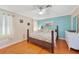 Cozy bedroom featuring a wooden bed frame, hardwood floors, and neutral paint at 7453 Spinnaker Blvd, Englewood, FL 34224