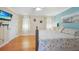 Cozy bedroom with a wooden bed frame, hardwood floors, and a mounted TV at 7453 Spinnaker Blvd, Englewood, FL 34224