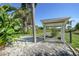 Covered carport offering protection from the elements with mature tropical landscaping at 7453 Spinnaker Blvd, Englewood, FL 34224