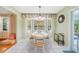 Bright dining area with a round table, bay window, and tiled floors at 7453 Spinnaker Blvd, Englewood, FL 34224
