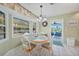 Bright dining area with a round table, bay window, and access to the patio at 7453 Spinnaker Blvd, Englewood, FL 34224