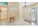 Bright foyer featuring tile flooring, a charming chandelier, and easy access to the home's layout at 7453 Spinnaker Blvd, Englewood, FL 34224