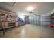 Spacious two car garage with storage shelves and tool rack, perfect for a workshop at 7453 Spinnaker Blvd, Englewood, FL 34224