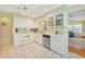 Well-lit kitchen with white cabinetry, modern appliances, and an open layout at 7453 Spinnaker Blvd, Englewood, FL 34224