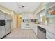 Bright kitchen features stainless steel appliances, white cabinetry, and tile flooring at 7453 Spinnaker Blvd, Englewood, FL 34224