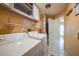 Functional laundry room features a side-by-side washer and dryer and storage shelving at 7453 Spinnaker Blvd, Englewood, FL 34224