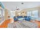 Comfortable living room featuring hardwood floors, large sofa, and natural light at 7453 Spinnaker Blvd, Englewood, FL 34224