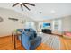Inviting living room with light walls, plush furniture, and a mounted television at 7453 Spinnaker Blvd, Englewood, FL 34224