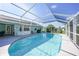 Relaxing screened-in pool with clear water, ideal for enjoying sunny days in privacy at 7453 Spinnaker Blvd, Englewood, FL 34224