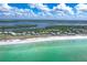 Stunning aerial view of beach homes along the shore with turquoise water and lush greenery at 7500 Palm Island S Dr # 2111, Placida, FL 33946