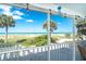 Screened balcony with ocean view and palm trees at 7500 Palm Island S Dr # 2111, Placida, FL 33946