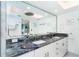 Bathroom with blue granite countertop, double sinks, and bright lighting at 7500 Palm Island S Dr # 2111, Placida, FL 33946