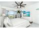 Beach-themed bedroom with ocean view, ceiling fan, and light, airy decor at 7500 Palm Island S Dr # 2111, Placida, FL 33946