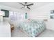 A bright bedroom with white walls, tile floors, and a ceiling fan at 7500 Palm Island S Dr # 2111, Placida, FL 33946