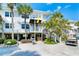 Inviting elevated coastal condo showcasing a pristine white exterior and lush tropical landscaping at 7500 Palm Island S Dr # 2111, Placida, FL 33946