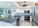 Bright kitchen featuring granite counters, stainless steel appliances, and white cabinets at 7500 Palm Island S Dr # 2111, Placida, FL 33946