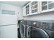 Well-equipped laundry room with a modern washer-dryer and ample storage cabinets at 7500 Palm Island S Dr # 2111, Placida, FL 33946