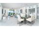 Open-concept living and dining area with tile floors and water view at 7500 Palm Island S Dr # 2111, Placida, FL 33946