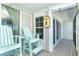 Inviting porch with light blue Adirondack chairs, ocean views, and coastal decor at 7500 Palm Island S Dr # 2111, Placida, FL 33946