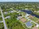 Aerial view of a residential neighborhood bordering a waterway, showcasing waterfront homes at 9151 Melody Cir, Port Charlotte, FL 33981