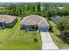 Aerial view of the beautiful home with a lush lawn in a neighborhood with mature trees at 9151 Melody Cir, Port Charlotte, FL 33981